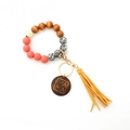 Detail of beaded keychain bracelet with leopard print wood beads and MAMA engraved disk - Yellow