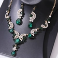 Detail of luxury bridal jewelry set with green teardrop gems and white crystals - Necklace and Earring Set / Gold/Green/White