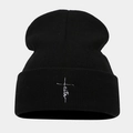Dettaglio del berretto in maglia a coste nere con ricamo a croce faith bianco - Nero