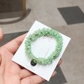 Elastic crystal beaded hair tie in light green with a gold charm and branded card - Green