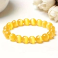 Yellow beaded bracelet with cat eye stone effect shown in a single strand on white base - 10mm Yellow