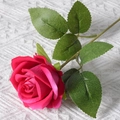 Single artificial red velvet rose flower with green leaves on white knit background - Freud (Velvet Version)
