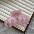 Pink translucent acrylic shark hair claw clip presented on a soft velvet jewelry tray - 11cm Vertebrae Style / Jelly Pink