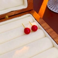 Close-up of minimalist red pearl stud earrings with gold pins in a jewelry box - Plated Red Round Bead 8mm