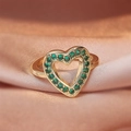 Detailed macro shot of a gold heart ring featuring pave-set emerald green zircons on satin - Large Green Heart/Gold Hollow