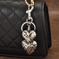 Double-layered leopard print heart keychain with silver lobster clasp on black bag - Leopard Double Heart