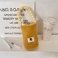 Detail of yellow fuzzy lamb wool cup carrier bag with cute black cat patch and plaid handle - Yellow