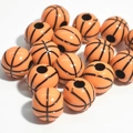 Macro view of orange acrylic basketball beads with classic black lines for jewelry making - 12mm Basketball Orange Black Line