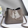 Elegant taupe crocodile pattern tote bag in glossy finish with gold buckle detail - Gray