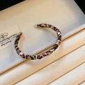 Detail of leopard print twisted cuff bracelet with gold metal end beads on soft lining - Single Layer Brown Leopard Twisted Style