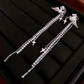 Detailed macro view of silver pegasus earrings with sparkling zircon tassels and stars - Ear Clip - Silver