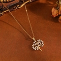 Macro shot of gold-plated hollow Tree of Life pendant with sparkling crystals and fine chain - Gold White Zircon Tree Necklace (T031)
