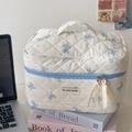 Quilted floral makeup bag with blue ribbon zippers on pastel books background - Large Cosmetic Bag / Blue