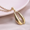 Close-up of golden shell pendant necklace with detailed texture and 18k plating - Gold Necklace