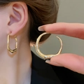 Close-up of gold irregular twisted hoop earrings showing high gloss finish on model - Gold Irregular Round Style (109#)