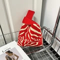Knit knot bag featuring red and cream zebra stripes for casual wrist carry - Red Zebra Print