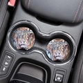 Close-up of two highland cow car coasters with colorful illustration in a cup holder - Highland Cow Style 1