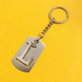 Brushed silver stainless steel keychain featuring a hollow letter L pendant on yellow back - L