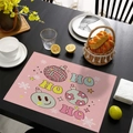 Pink Christmas placemat with HO HO HO text and festive holiday decorations on a table - CD57-20