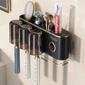 Wall-mounted dark grey toothbrush holder with gold trim and three translucent cups - 3-Cup Style + Toothpaste Squeezer-Gun Grey-Magnetic