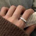 Silver-colored butterfly ring featuring geometric triangle relief on a hand - Geometric Triangle