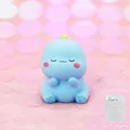 Cute blue dinosaur figurine with closed eyes and pink cheeks in a clear PVC gift box - 1A Sky Blue - Sitting Position (Generation 1 Mini)