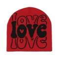 Detail view of red knit beanie featuring black LOVE jacquard lettering and soft texture - M (56-58cm) / Red