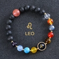 Close-up of Leo zodiac beaded bracelet with black lava stone and engraved central bead - Leo