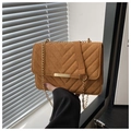 Close-up of brown suede crossbody bag with V-quilt pattern and gold metal hardware - Brown