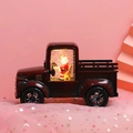 Detail of red vintage Christmas truck lantern with Santa figure and glowing LED light - Wine Red Tractor