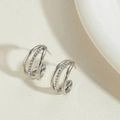 Macro view of silver C-shape earrings with triple-layered structure and white zircon stones - Multi-Layer Triple Wire Zirconia / Silver