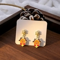 Macro shot of asymmetric Christmas earrings with snowflake and cute deer designs - E5947-4 Snowflake Reindeer Bell