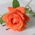 Single orange velvet artificial rose with green leaves on a white background - Orange
