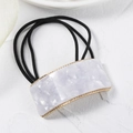 Detail of lavender marble acetate square buckle and gold metal frame on black hair tie - White