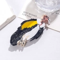 Macro shot of vulture-shaped acetate hair claw clip with black and white details - Vulture