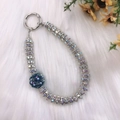 Silver rhinestone phone charm with deep blue fabric flower on white plush background - Dark Blue Fabric Flower with Pearl