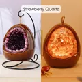 Egg-shaped strawberry quartz night light with warm LED glow and black metal stand - Dinosaur Egg Night Light - Strawberry Quartz