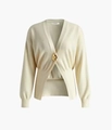 Detailed view of cream knit cardigan featuring a V-neck and a large gold statement button - Beige