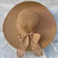 Foldable wide brim straw sun hat for women featuring a large decorative bow in light brown - One Size (55-58cm) / Khaki