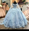 Close-up of light blue Quinceañera dress featuring detailed 3D butterfly and floral appliques - Light Blue Floor-length Style
