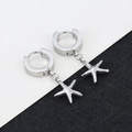 Macro shot of silver starfish charm earring with polished finish on a modern backdrop - Small Starfish - Steel