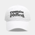 Close-up of black 'Expensive & Difficult' embroidery on a white cotton baseball cap - Adjustable / White
