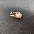 Detail of gold wire wrapped ring with a pink crystal bead in bohemian style - Adjustable Open / Sunstone