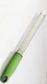 Green handled stainless steel grater for cheese and lemon zest on white background - Heart Green