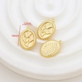 Detail of vintage gold floral oval pendants 18mm x 12mm showing embossed texture - Tulip Oval
