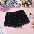 Macro detail of high-waist black sequin shorts with delicate eyelash lace hem stitching - S / Black