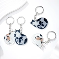 Detailed view of three acrylic cat keychains with watercolor ink style cat patterns - Acrylic Cat