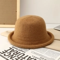 Close-up of camel wool knit bucket hat texture on a minimalist lifestyle background - Khaki