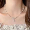 Close-up of pearl necklace with silver triple ring diamond pendant on a model neck - 67# Pink Rose Three-Ring Necklace
