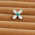 Macro shot of silver floral cartilage stud with green zircon and white crystals - Four-Leaf Clover Style (E1357-8)